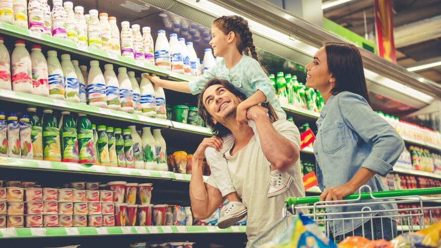 young family walking down grocery store aisle