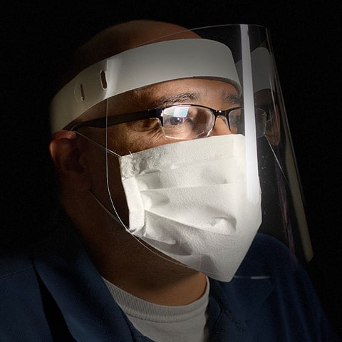 Man wearing face shield and mask