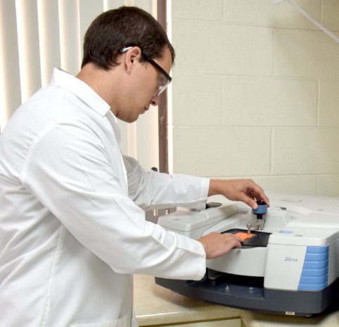 man in Primex lab working on machine