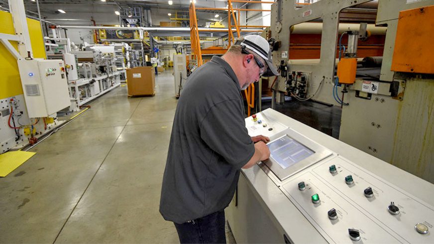 primex manufacturing team member working on equipment