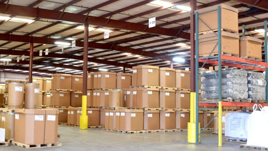 view of production floor filled with stacked boxes of product