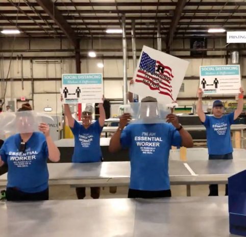 Primex team members holding up signs