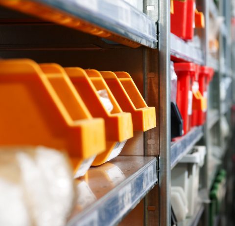 shelf with orange plastic containers