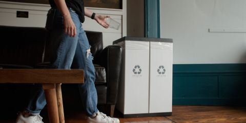 Recycling bin being used for plastic drink cups