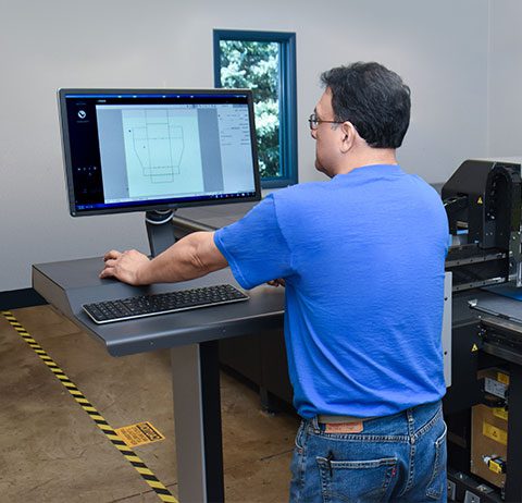 man working at standing desk