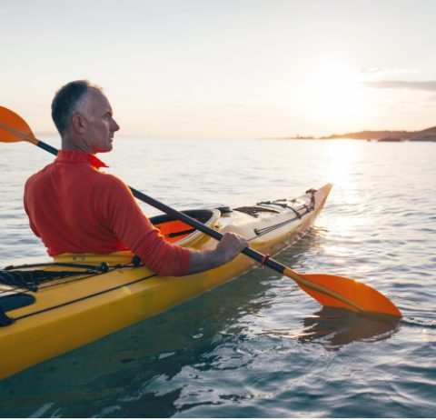 man kayaking in river