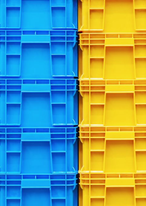 yellow and blue plastic crates stacked on top of each other